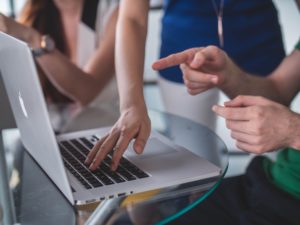 People sharing a laptop
