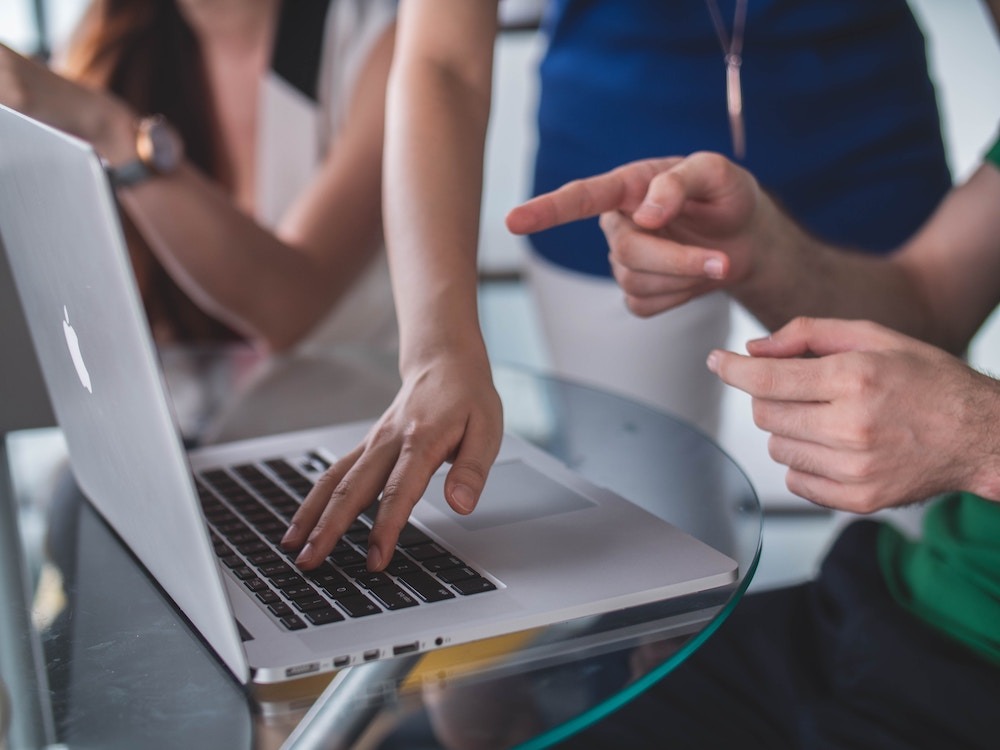 People sharing a laptop