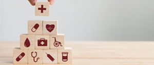 Hand arranging wood block stacking with icon healthcare medical, Insurance for your health concept